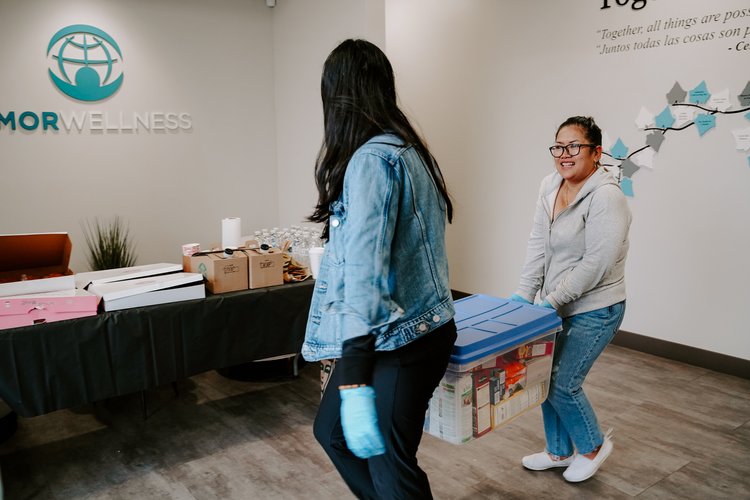 Two women working a thanksgiving food drive