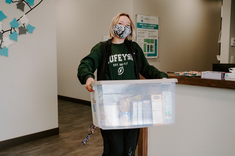 Woman holding a bin of food