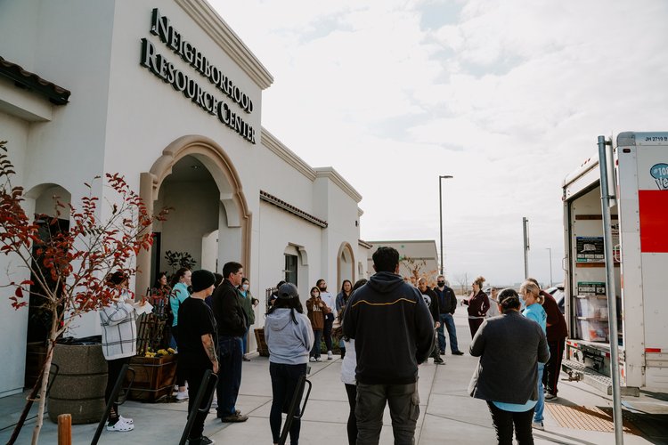 Multiple people outside of Neighborhood Resource Center building