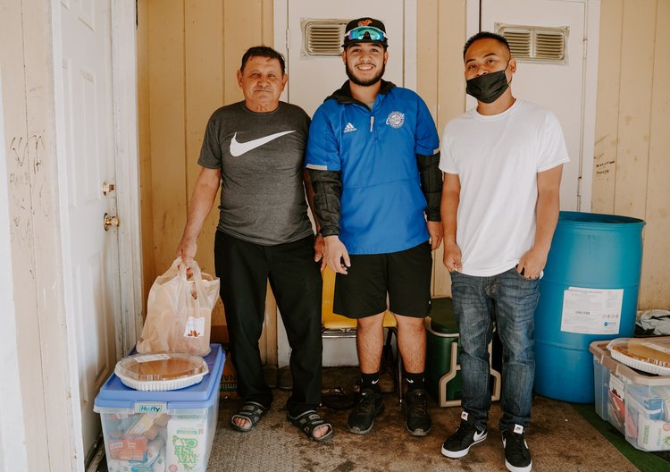 Three men working the Thanksgiving food drive