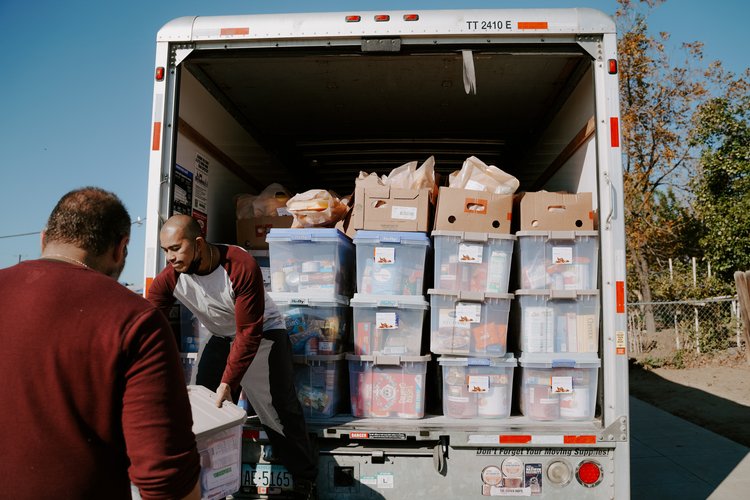 Truck filled with bins from a Thanksgiving food drive